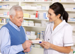 a pharmacist giving some medications to the customer